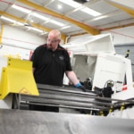 Worker deburring a metal part