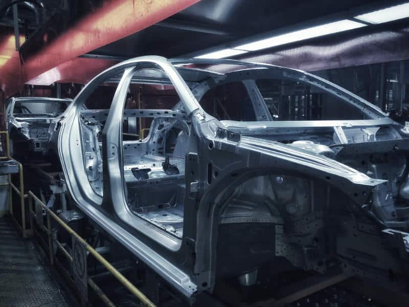 Car chassis undergoing electrophoretic coating.