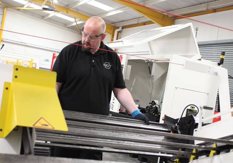 Worker deburring a metal part